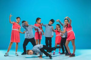 The kids dance school, ballet, hiphop, street, funky and modern dancers on blue studio background